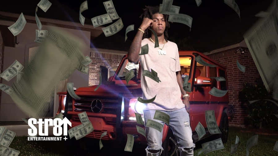 A Man Standing In Front Of A Red Truck With Money Falling From It Wallpaper