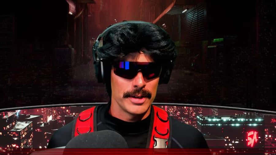 A Man With A Mustache And Headphones Is Sitting In Front Of A Computer Wallpaper
