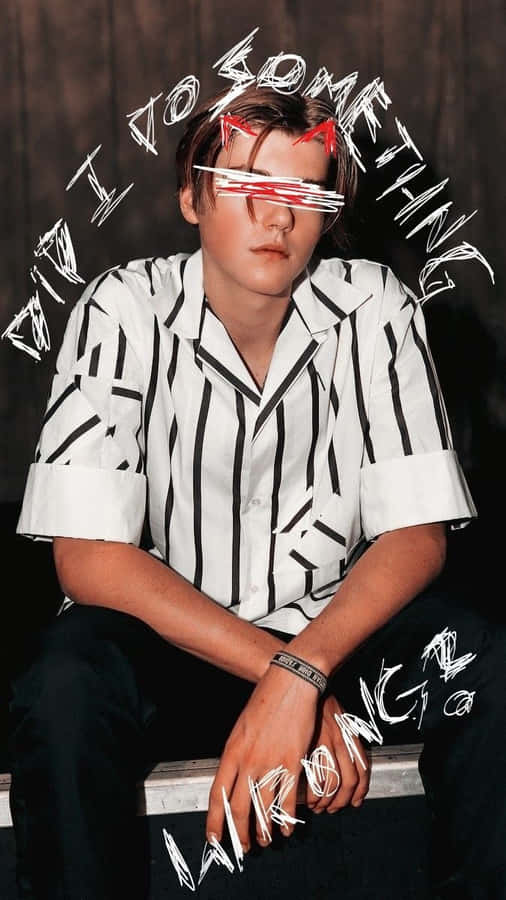 A Man With Glasses Sitting On A Bench Wallpaper