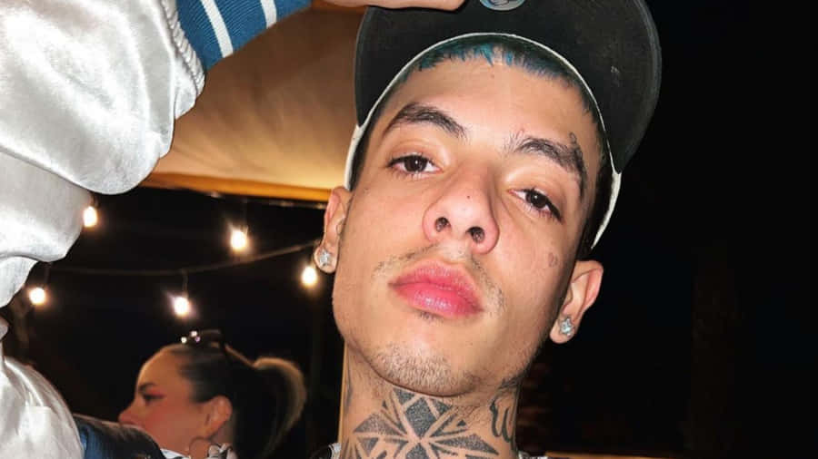 A Man With Tattoos On His Head Is Posing Wallpaper