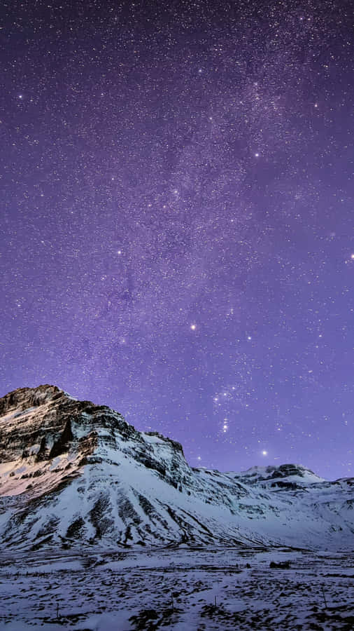 A Mountain With Snow And A Milky Above It Wallpaper