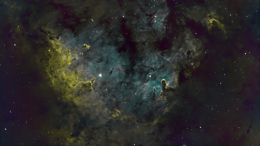 A Nebula With Stars And Green And Yellow Wallpaper