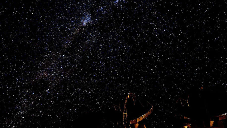 A Night Sky With A Starry Sky And A Telescope Wallpaper