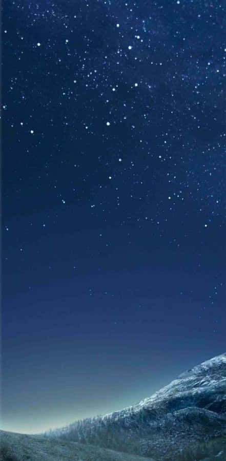 A Night Sky With Stars And A Mountain Wallpaper