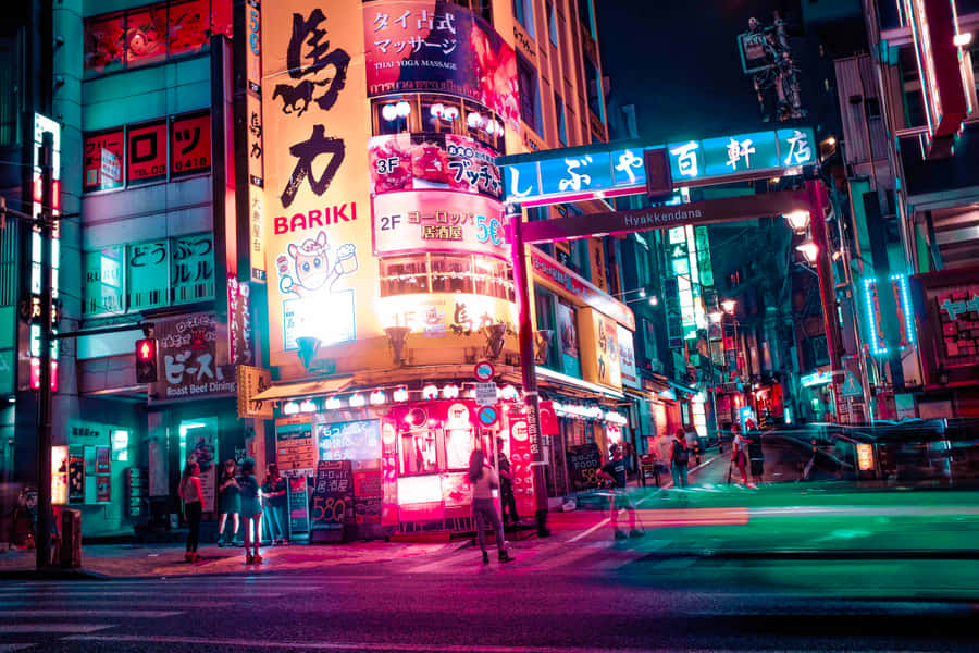 A Nightscape Of Tokyo Illuminated With Japanese Neon Signs Wallpaper