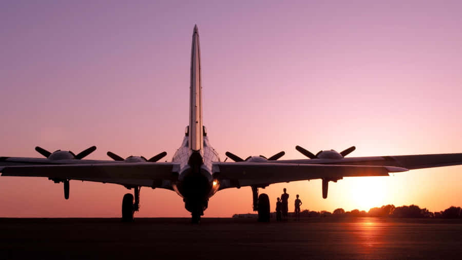 A Pink Plane Flying Across A Blue Sky Wallpaper