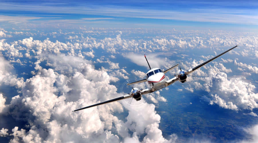 A Plane Flying Through The Clouds Wallpaper