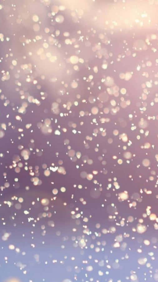 A Purple And Pink Background With Snowflakes Wallpaper