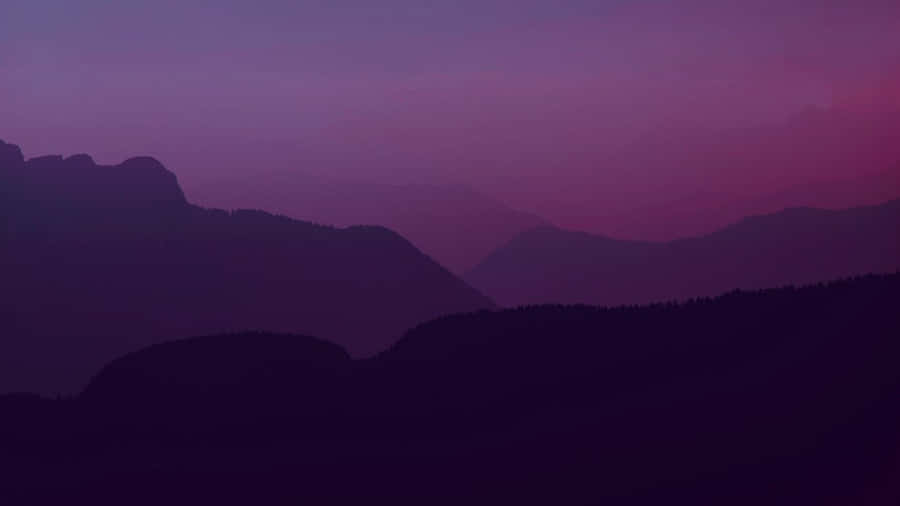 A Purple Sky With Mountains Wallpaper