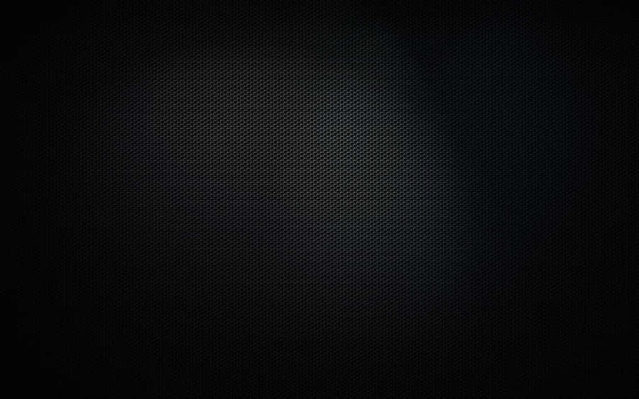 A Sleek Surface Of Black Metal Glitters In The Light. Wallpaper