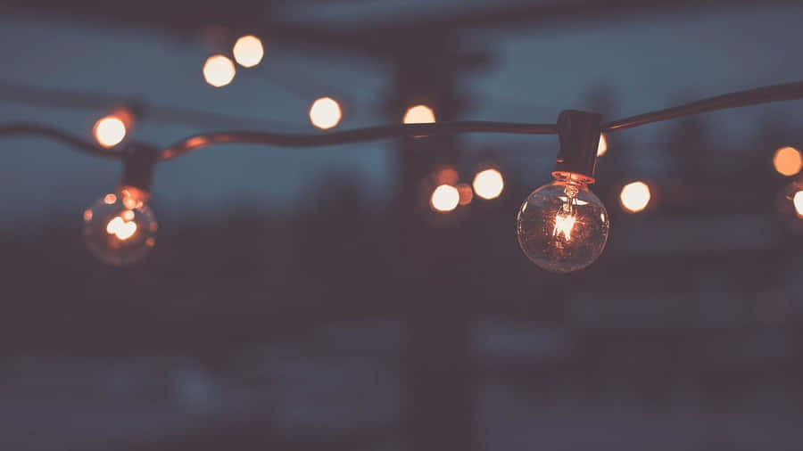 A String Of Lights With Lights On It Wallpaper