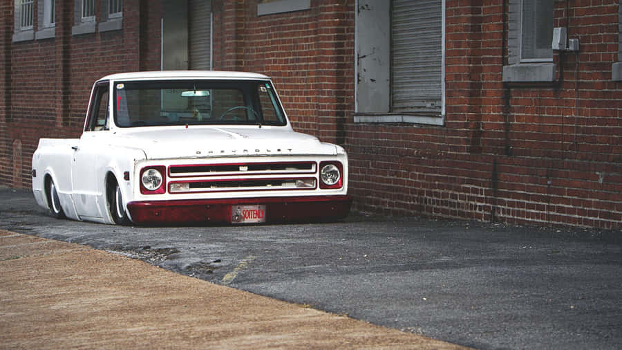 A White Truck Parked On The Side Of The Road Wallpaper