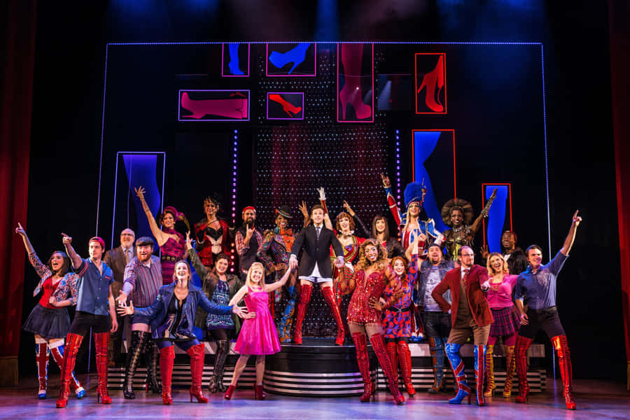 Actors Taking The Stage In A Musical Theatre Performance. Wallpaper
