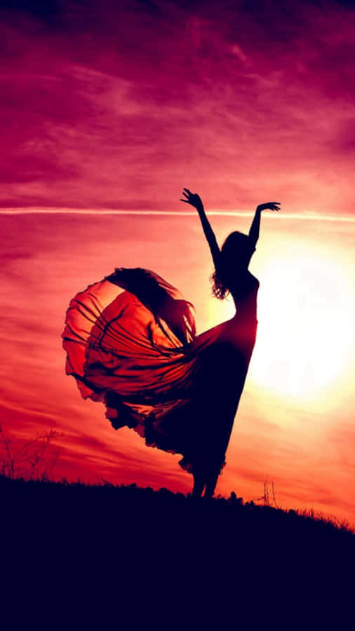 Aesthetic Sunset Iphone With Silhouette Of Woman Wearing A Dress Wallpaper