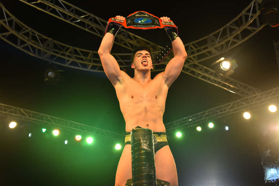 Aew Star Sammy Guevara Triumphantly Holding A Championship Belt Wallpaper