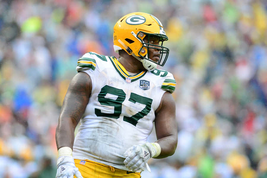 American Football Defensive Tackle Kenny Clark On Field Wallpaper