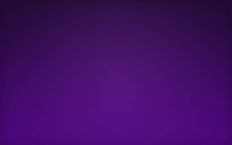 An Aesthetically Pleasing Home Office Setup Featuring A Purple Desktop Wallpaper