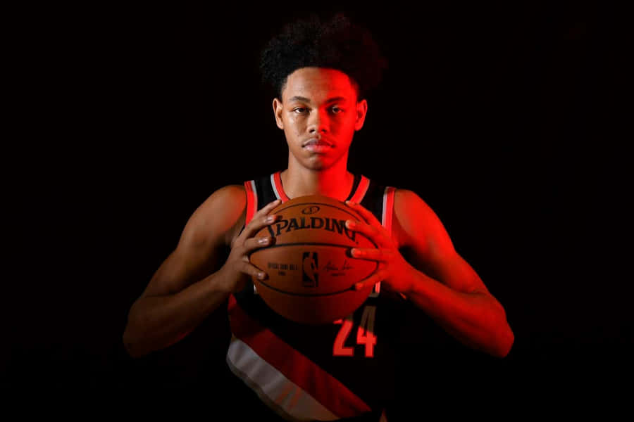 Basketball Player Holding Ball Dark Background Wallpaper