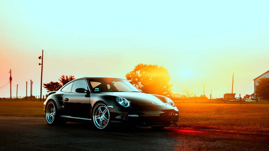 Black Car On Open Road Wallpaper