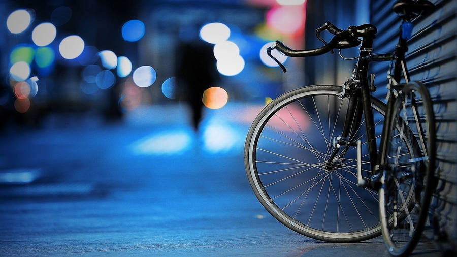 Black Road Bike In Bright Street Wallpaper