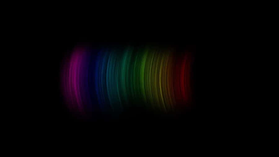 Brightly Colored Rainbow Cutting Through A Pitch Black Sky. Wallpaper