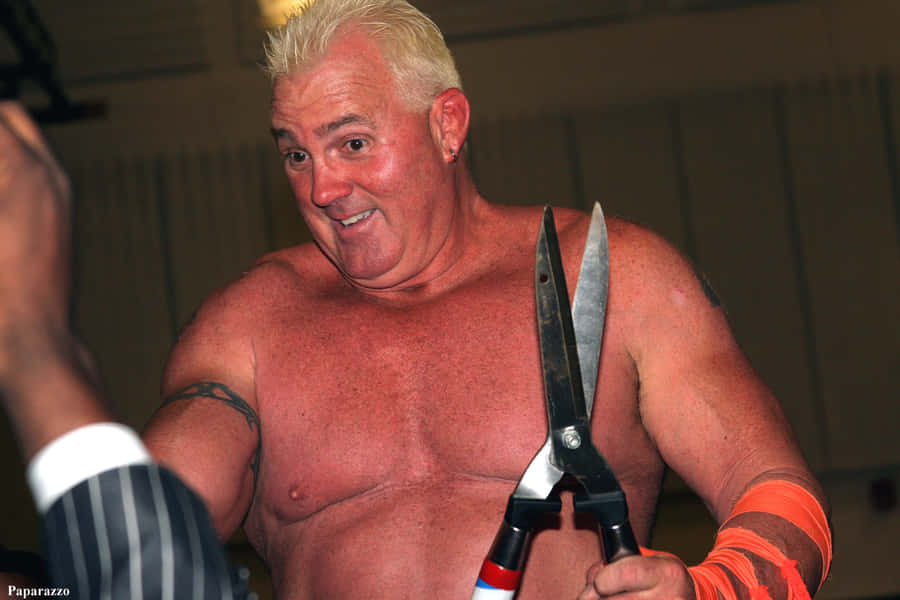 Brutus Beefcake Holding His Huge Scissors Wallpaper