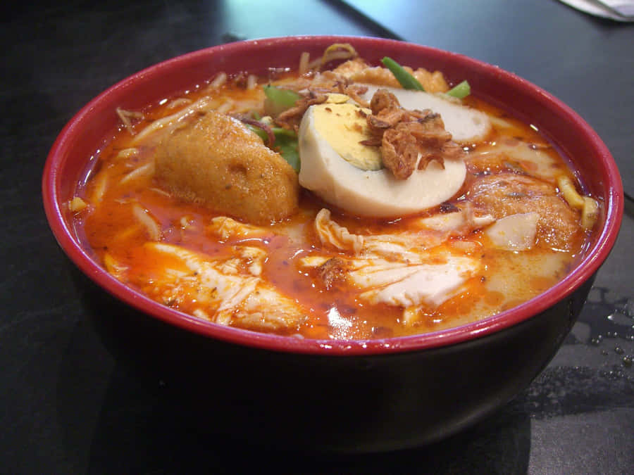 Caption: A Bowl Of Authentic Singaporean Coconut Curry Laksa Wallpaper