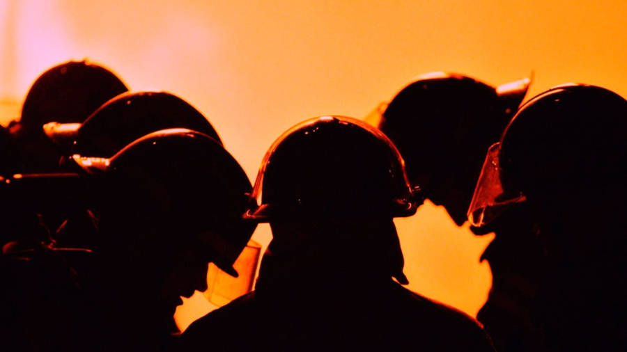 Caption: Brave Firefighters In Action Wallpaper