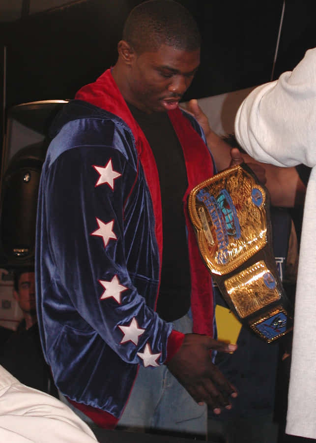 Caption: Shelton Benjamin Seizes Victory With Championship Belt Wallpaper