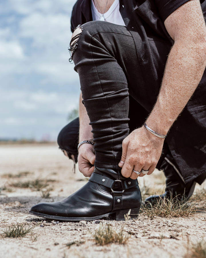 Caption: Sleek Black Strapped Leather Shoes Wallpaper