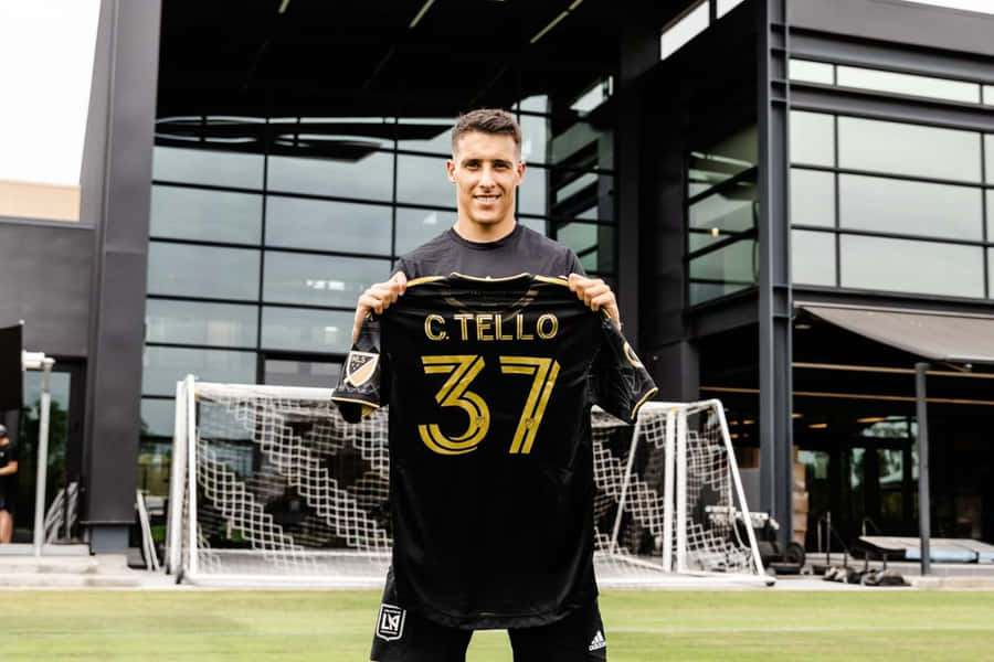 Cristian Tello Holding Jersey Number37 Wallpaper