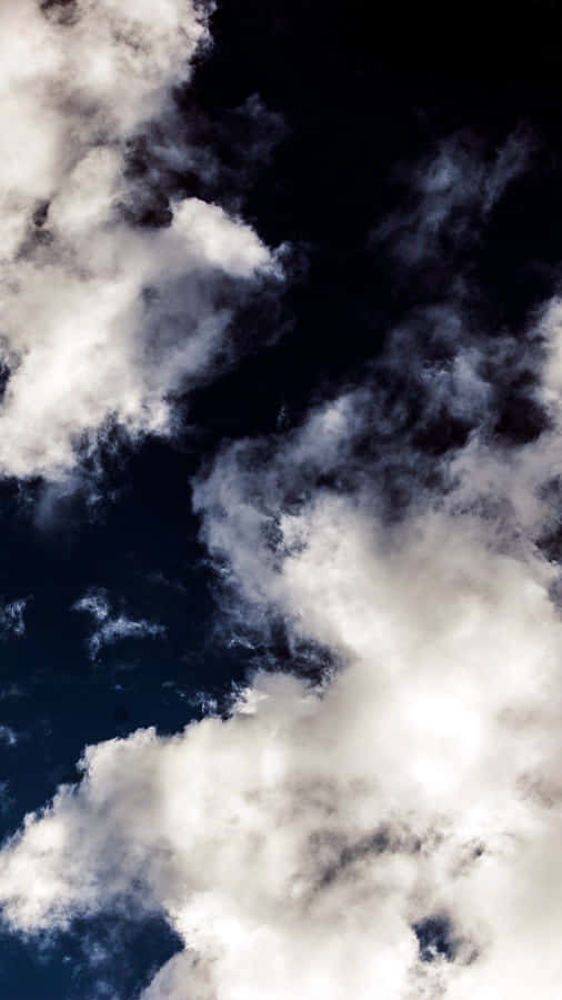 Enjoy The Beauty Of A Sky Full Of Clouds Wallpaper