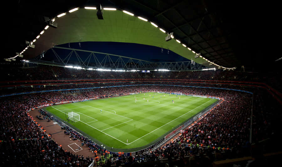 Enjoying A Game Of Soccer At A Stadium Wallpaper