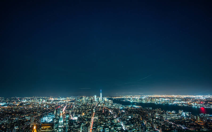 Exploring The Bright City Lights At Night Wallpaper