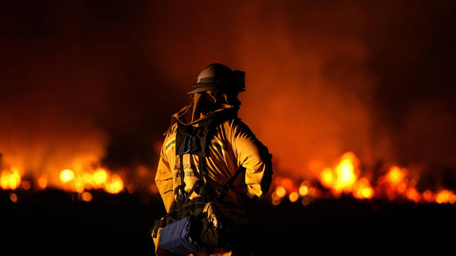 Firefighters In Front Of A Burning Space Wallpaper