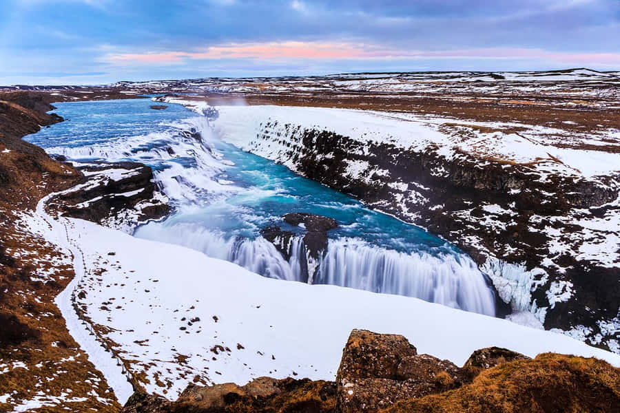 Gullfoss Waterfall With Perennial Snow In Southwest Iceland Wallpaper