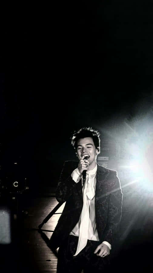 Harry Styles Black And White Photo On Stage Wallpaper