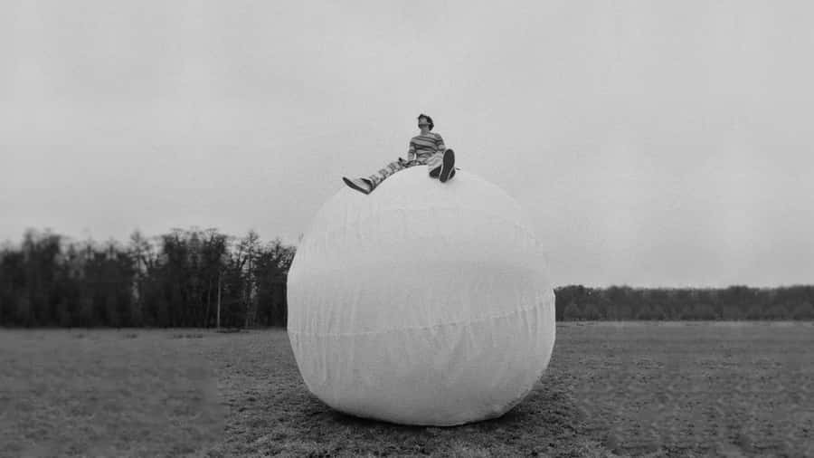 Harry Styles Brings Intensity And Style In A Black And White Photo. Wallpaper