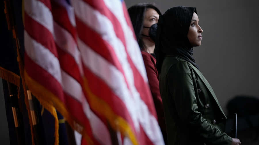 Ilhan Omar Beside The Us Flag Wallpaper