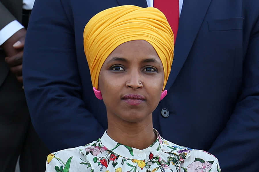 Ilhan Omar In A Yellow Hijab Wallpaper
