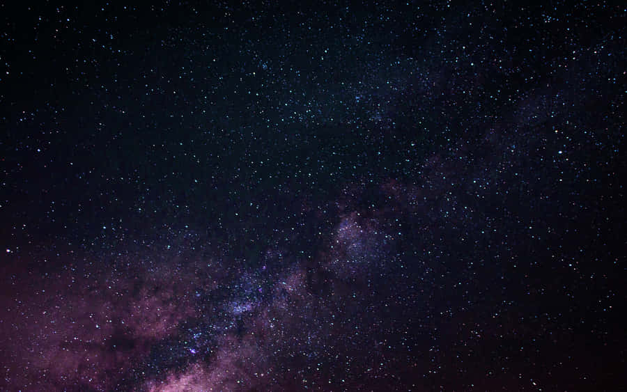 Image Fascinating View Of The Night Sky Above A Dark City Wallpaper
