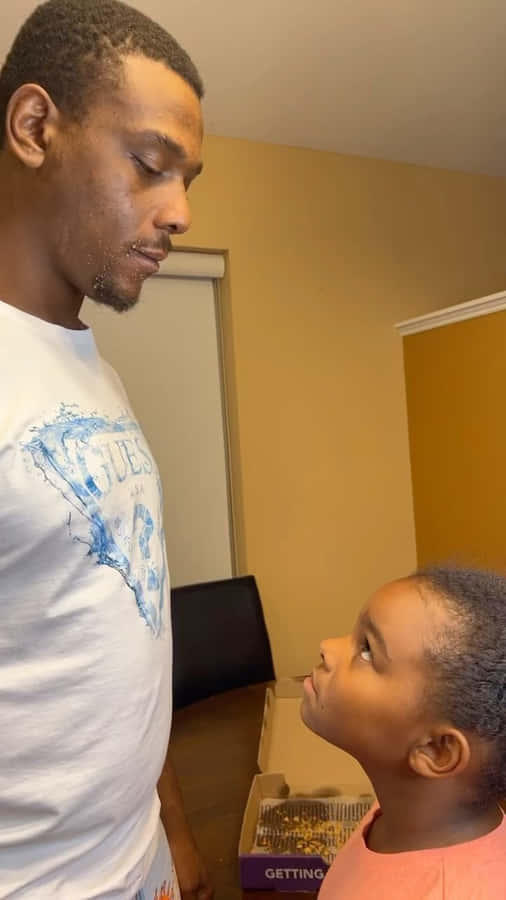 Jamahal Hill Looking At His Kid Wallpaper