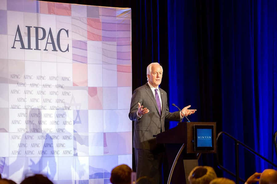 John Cornyn Speaking On A Stage Wallpaper