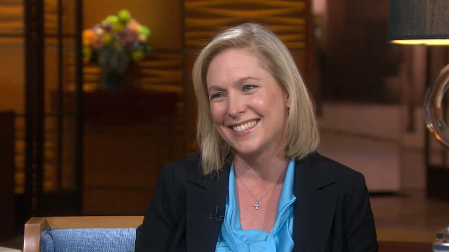 Kirsten Gillibrand Smiling During An Interview Wallpaper