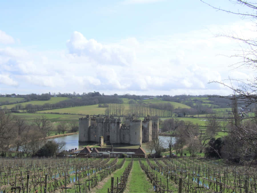 Majestic Bodiam Castle In England Reflecting Off The Moat Wallpaper