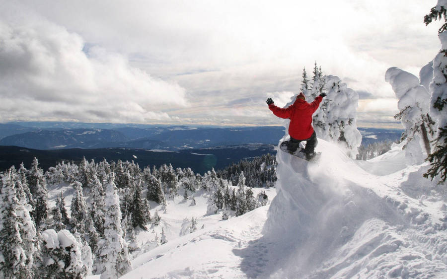 Man In Red With A Snowboard Leaping Wallpaper