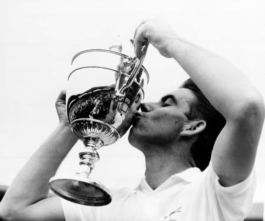 Manuel Santana Kissing His Trophy After Victory Wallpaper