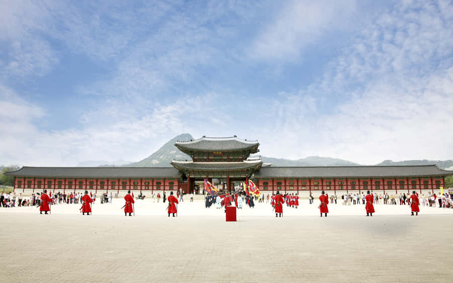 Men In Red At Gyeongbokgung Palace Wallpaper
