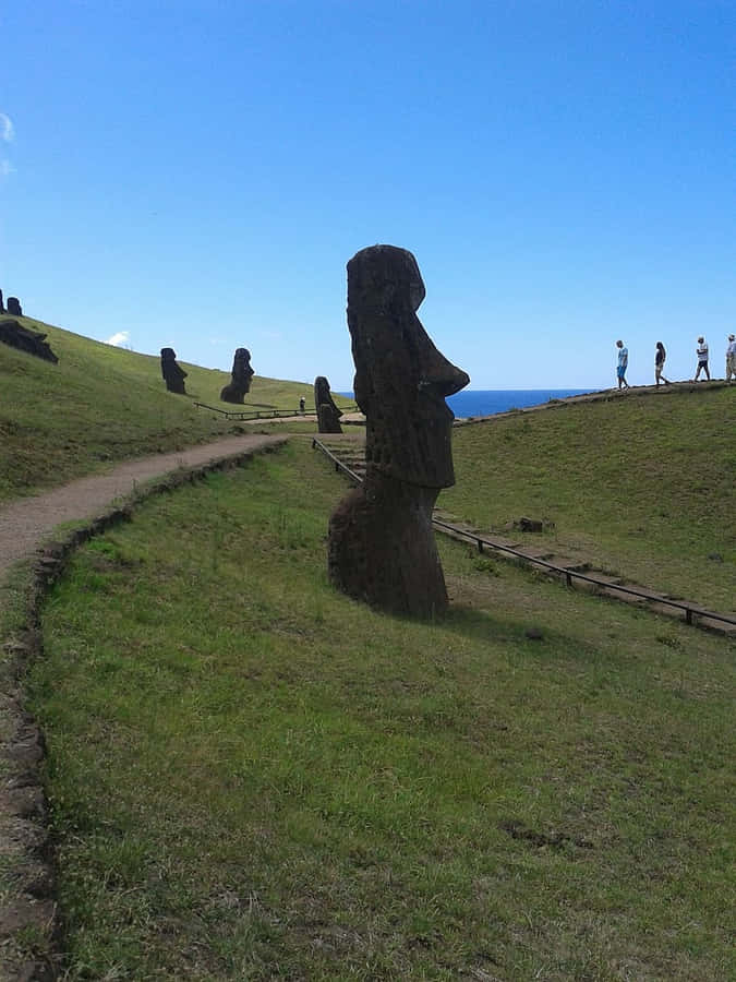 Moai Figures With Tourists Wallpaper