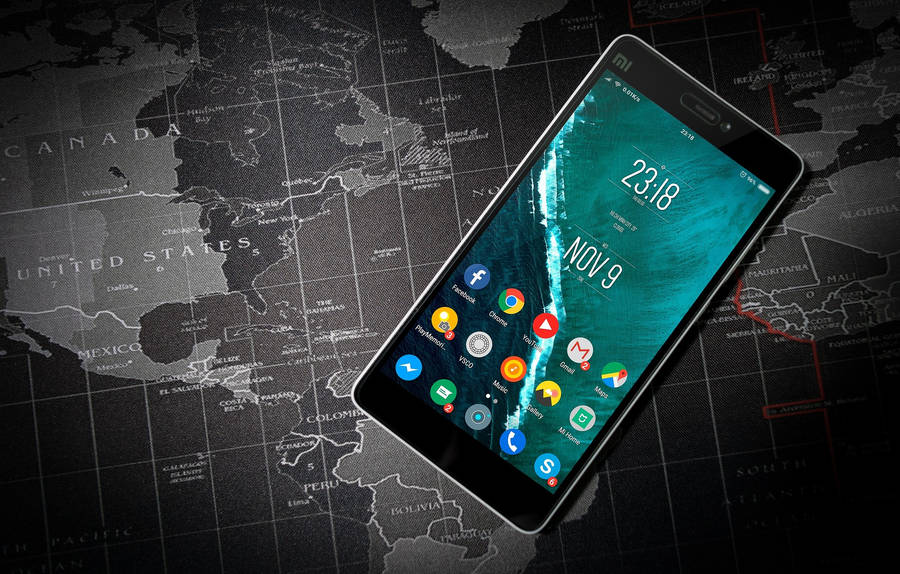 Mobile Phone On A Travel Map Wallpaper